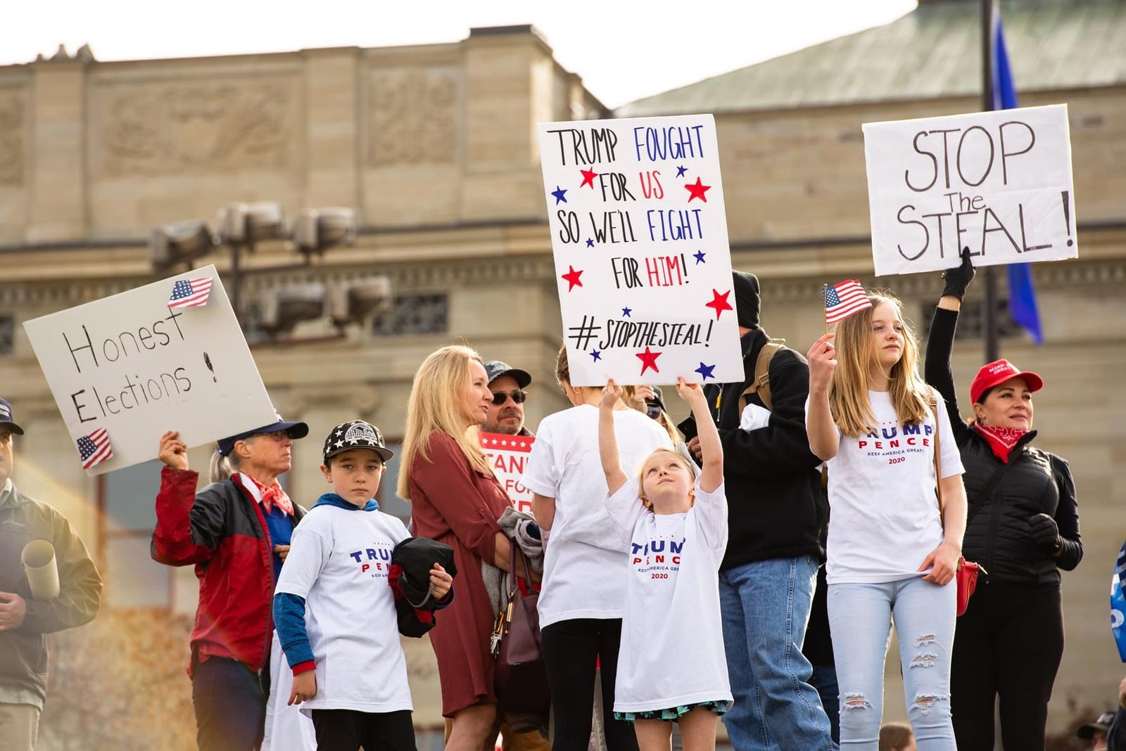 adults and children with stop the steal signs